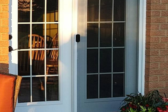 Window and mullion-style garden door replacment with shaker siding treatment under window located in Alma